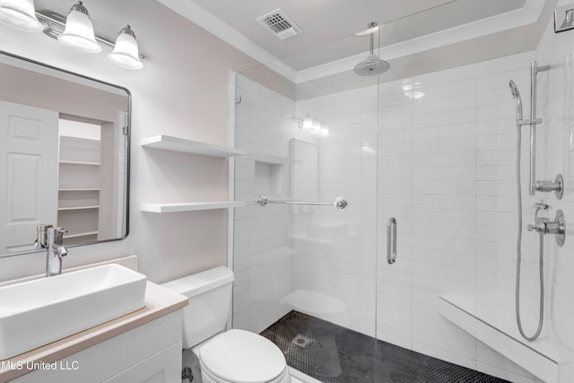 bathroom featuring visible vents, a stall shower, toilet, and vanity