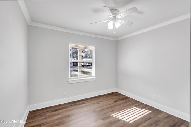 empty room with ornamental molding, ceiling fan, baseboards, and wood finished floors