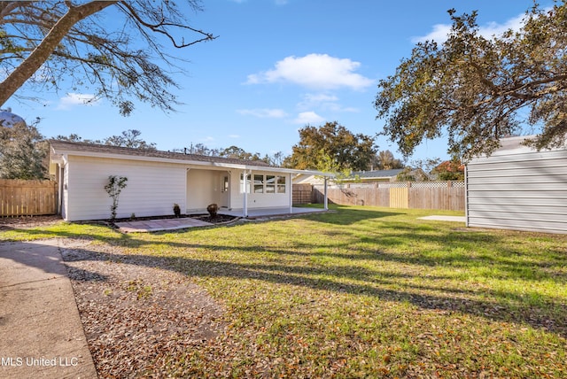 view of front of property featuring a front yard, fence, and a patio area