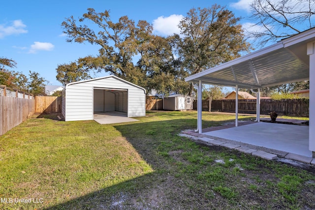 view of yard featuring an outbuilding, a patio, a fenced backyard, a storage shed, and a garage