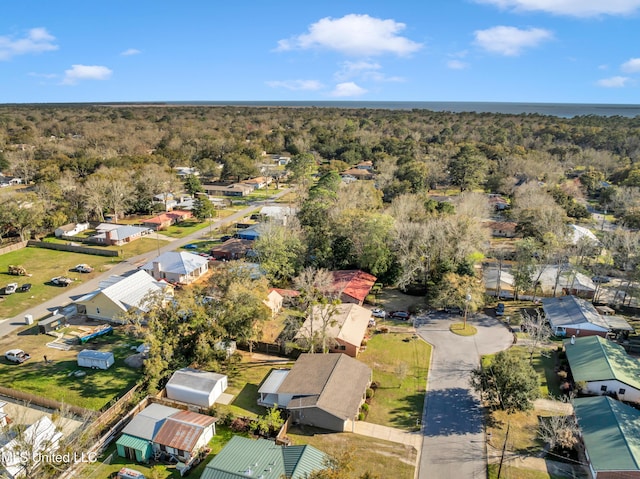 birds eye view of property featuring a wooded view