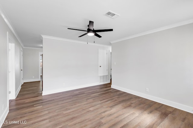 empty room with visible vents, baseboards, and wood finished floors