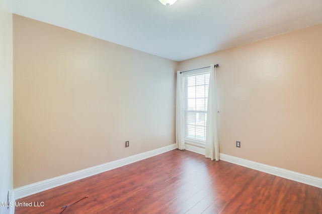 6909 N Rue Mornay, Biloxi, MS 39532 - spare room featuring dark wood finished floors and baseboards