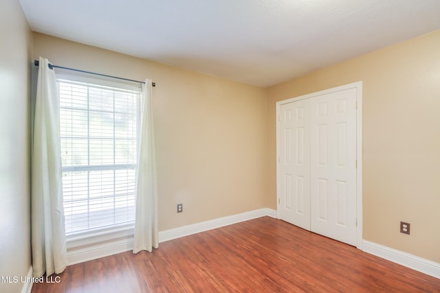 6909 N Rue Mornay, Biloxi, MS 39532 - unfurnished bedroom featuring wood finished floors and a closet