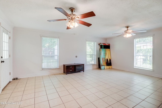 6909 N Rue Mornay, Biloxi, MS 39532 - unfurnished living room featuring ornamental molding, a ceiling fan, healthy amount of natural light, and light tile patterned floors
