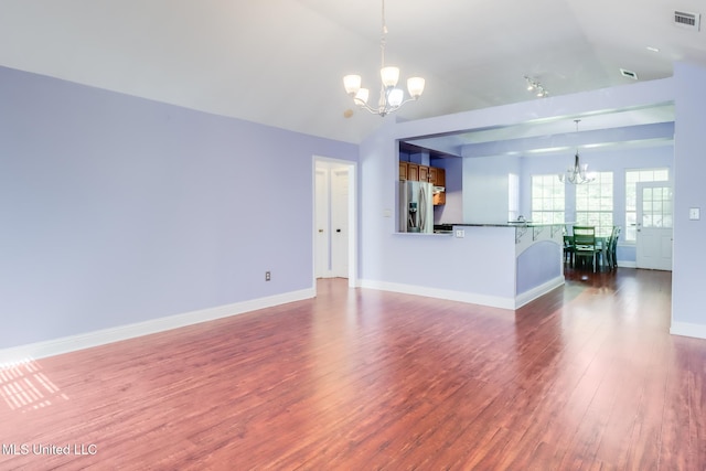 6909 N Rue Mornay, Biloxi, MS 39532 - unfurnished living room with a chandelier, dark wood finished floors, and lofted ceiling