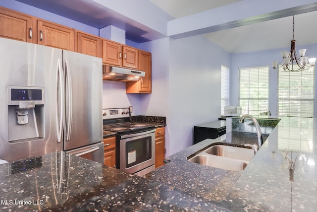6909 N Rue Mornay, Biloxi, MS 39532 - kitchen with appliances with stainless steel finishes, under cabinet range hood, a chandelier, dark stone counters, and hanging light fixtures