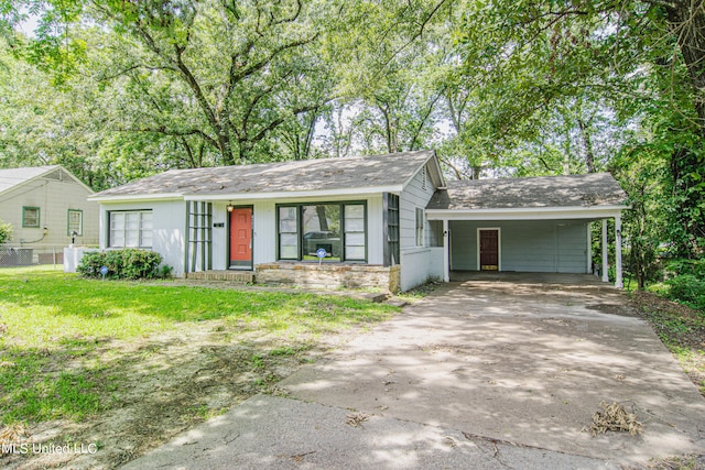 ranch-style house with a carport and a front lawn