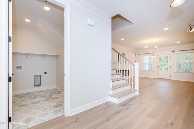 stairway featuring a notable chandelier, wood-type flooring, and ornamental molding