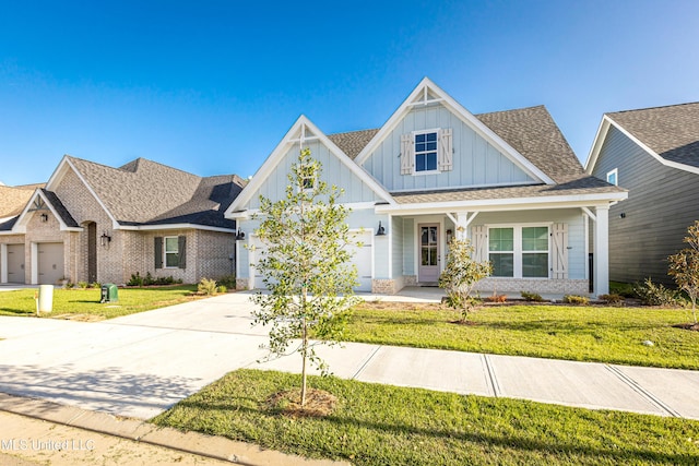 view of front of house with a garage, a front yard, and a porch