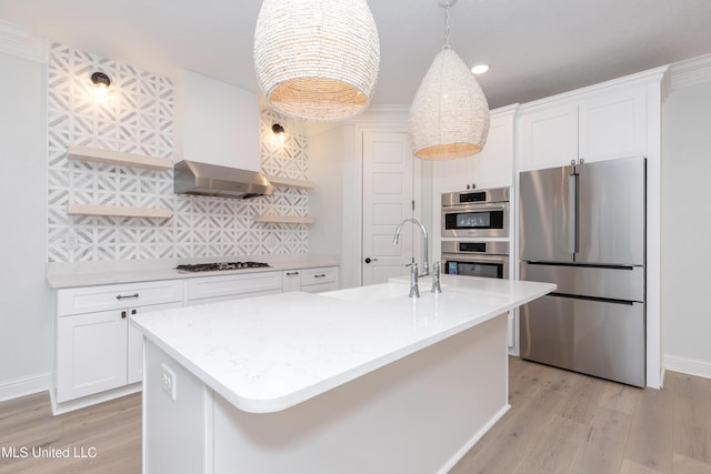 kitchen with a kitchen island with sink, sink, stainless steel appliances, and white cabinets