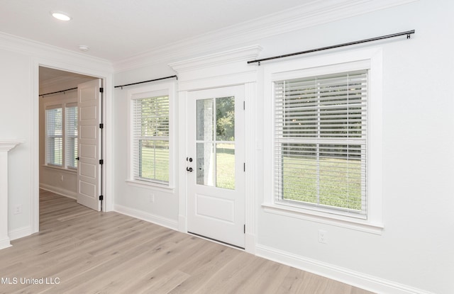 foyer with crown molding and light hardwood / wood-style flooring