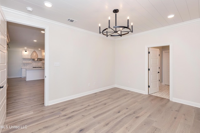 unfurnished dining area featuring ornamental molding, a chandelier, and light hardwood / wood-style floors