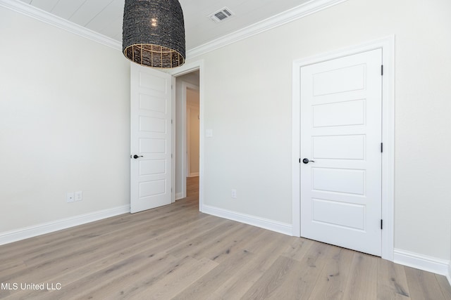 unfurnished room with crown molding and light wood-type flooring