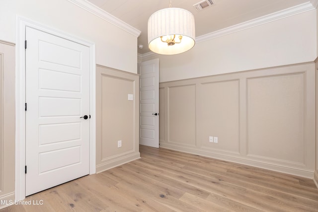 interior space featuring a notable chandelier, crown molding, and light hardwood / wood-style flooring