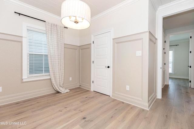 interior space featuring crown molding and light wood-type flooring