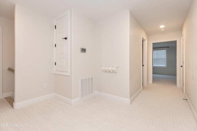 corridor featuring light tile patterned floors