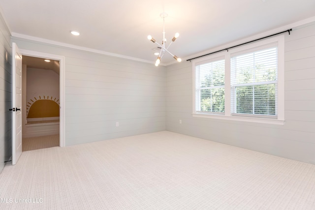 spare room with a chandelier