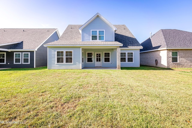 back of house with a yard and a patio area