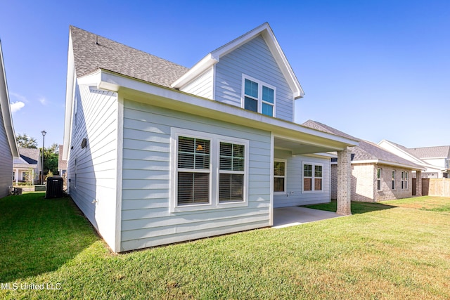 back of house featuring cooling unit, a yard, and a patio area