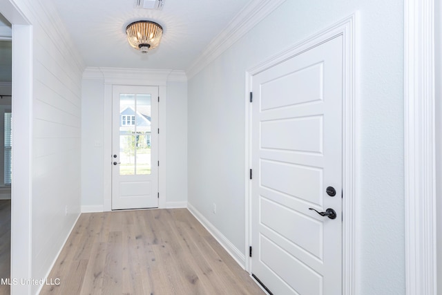 doorway with ornamental molding and light wood-type flooring