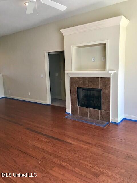 114 Silver Ridge Ln, Pearl, MS 39208 - unfurnished living room featuring wood finished floors, ceiling fan, and a tile fireplace