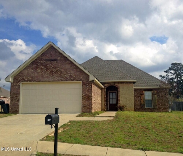 114 Silver Ridge Ln, Pearl, MS 39208 - view of front facade with brick siding, concrete driveway, a front yard, an attached garage, and a shingled roof