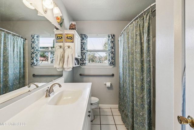 bathroom featuring tile patterned floors, plenty of natural light, vanity, and toilet