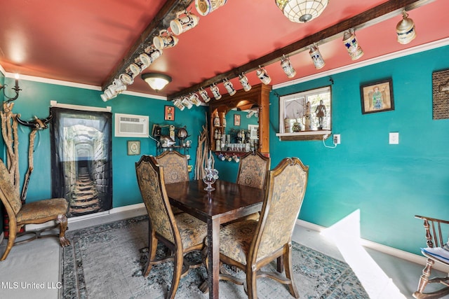 dining room with an AC wall unit, crown molding, and track lighting