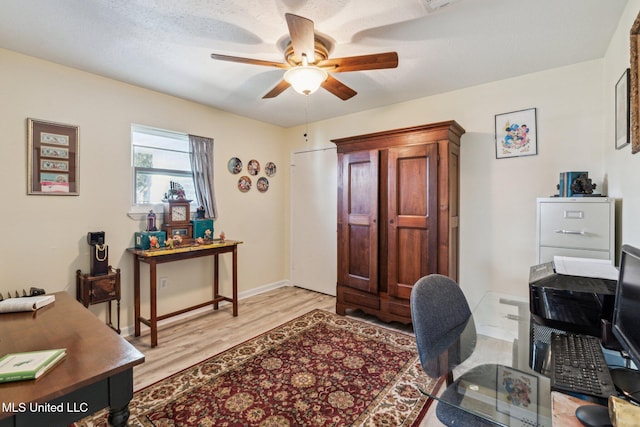 home office featuring ceiling fan and light hardwood / wood-style flooring