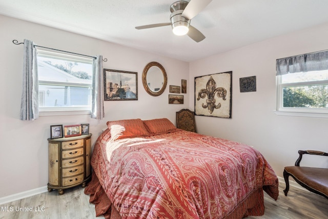 bedroom featuring hardwood / wood-style floors and ceiling fan