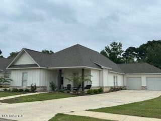 ranch-style house with a garage and a front lawn