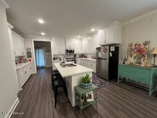 kitchen featuring white cabinetry, appliances with stainless steel finishes, sink, and dark wood-type flooring