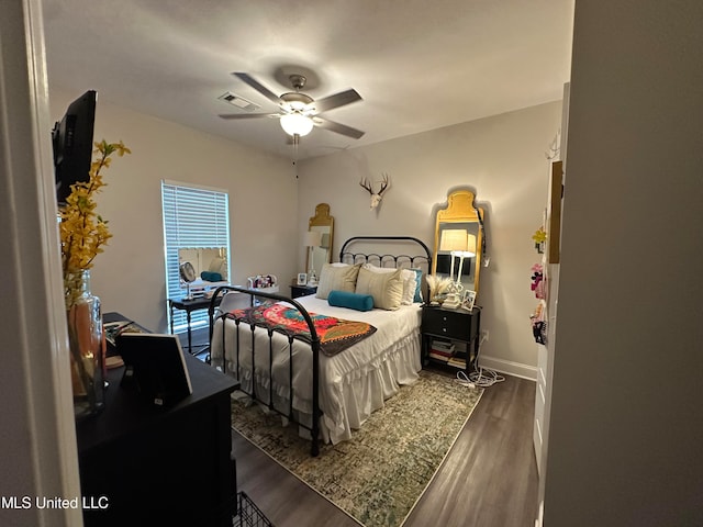 bedroom featuring ceiling fan and dark hardwood / wood-style floors