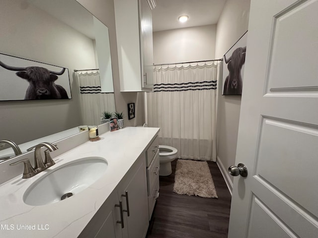 bathroom featuring vanity, wood-type flooring, toilet, and walk in shower