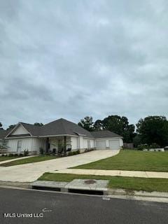 ranch-style home with a front yard and a garage