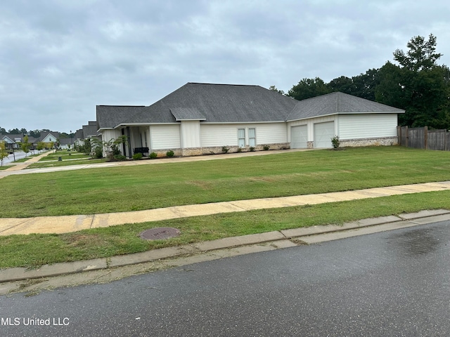 view of front facade with a garage and a front lawn