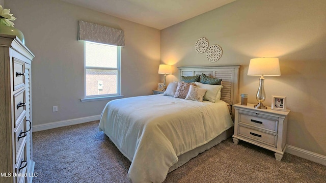 bedroom featuring dark carpet