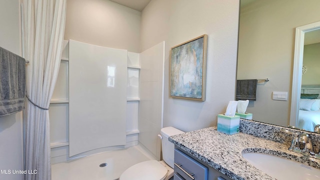 bathroom featuring vanity, toilet, and walk in shower