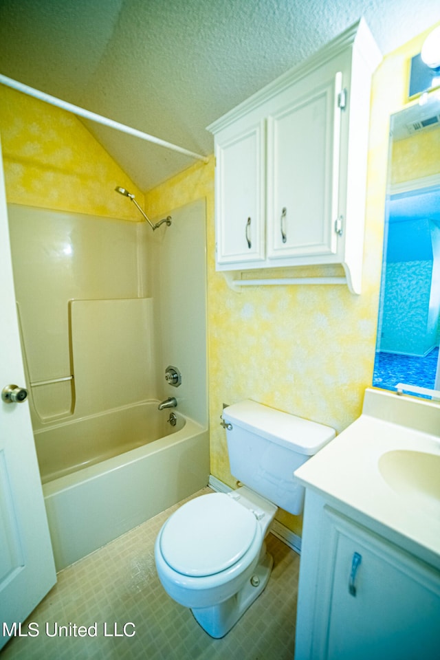 full bathroom featuring shower / washtub combination, a textured ceiling, vaulted ceiling, toilet, and vanity