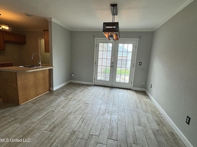 interior space featuring crown molding, sink, french doors, and light wood-type flooring