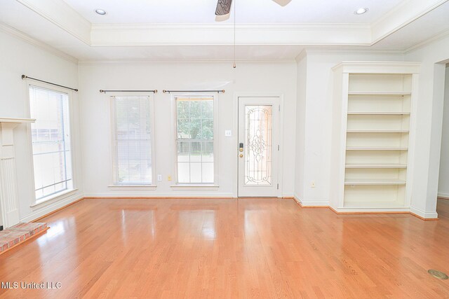 interior space with ornamental molding, a ceiling fan, and wood finished floors