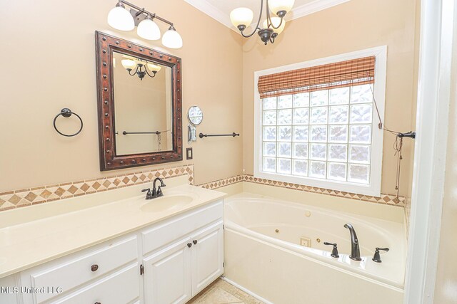 full bathroom with a tub with jets, ornamental molding, a notable chandelier, and vanity