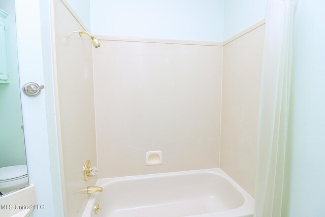 bathroom featuring toilet and shower / tub combination