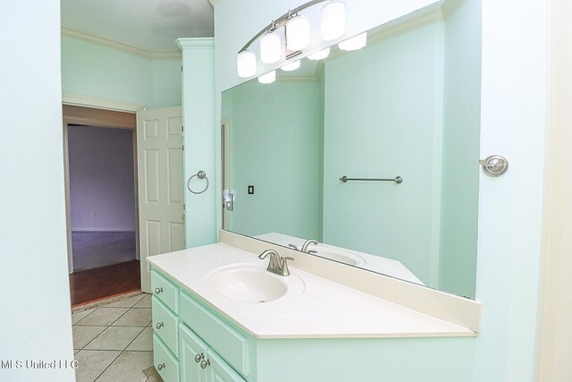 bathroom featuring tile patterned flooring, ornamental molding, and vanity