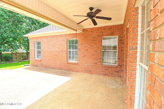 view of patio / terrace with fence and a ceiling fan