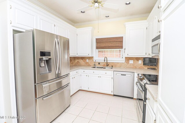 kitchen with a ceiling fan, backsplash, appliances with stainless steel finishes, a sink, and light countertops