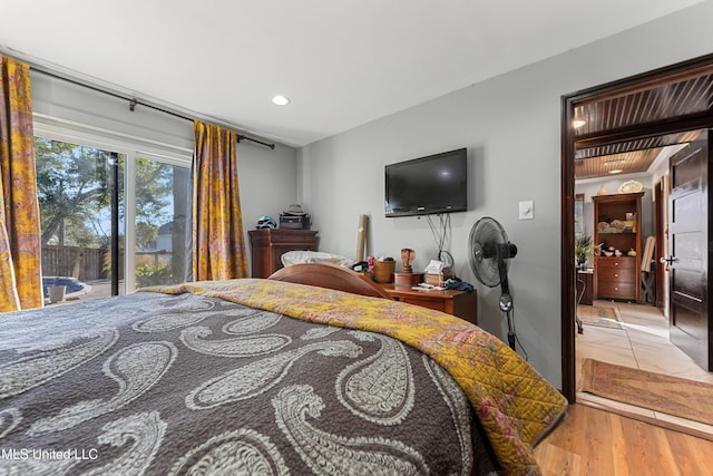 bedroom with access to outside and light hardwood / wood-style flooring