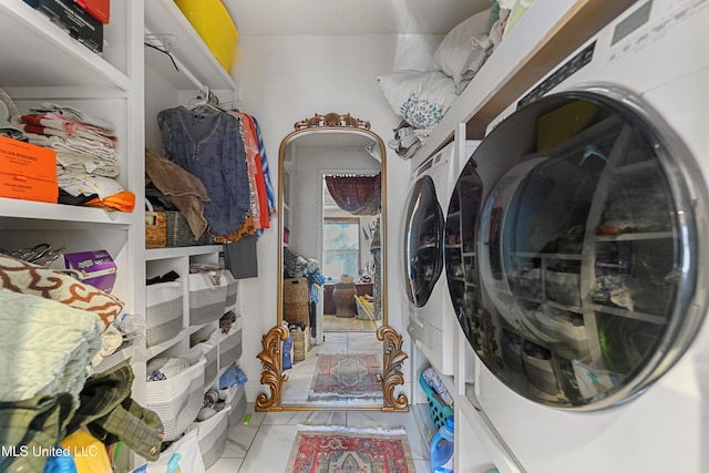 washroom with washer and clothes dryer and light tile patterned floors