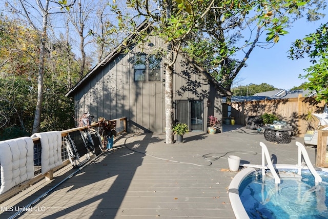 wooden terrace featuring a hot tub